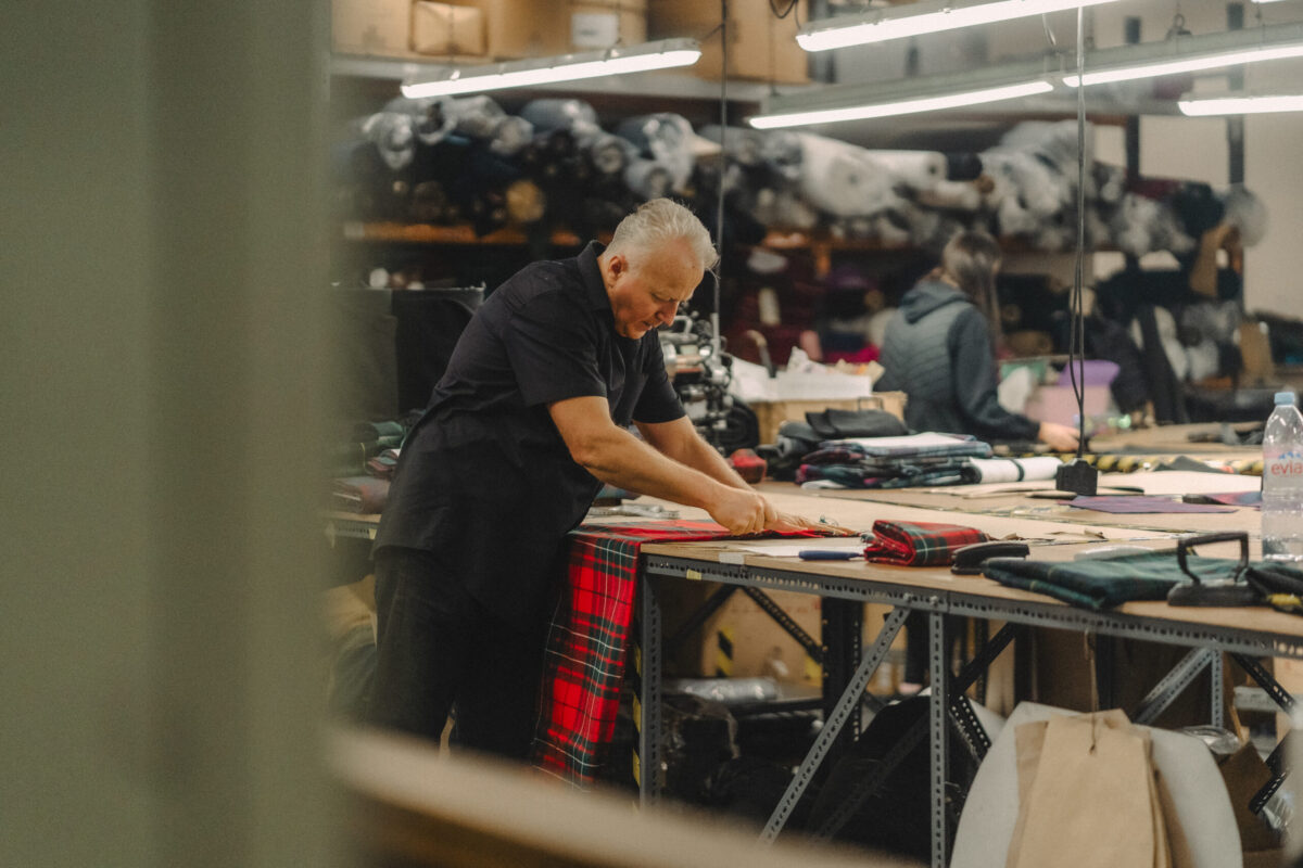 A Gaelic Themes cutter working with tartan in the Glasgow cutting room