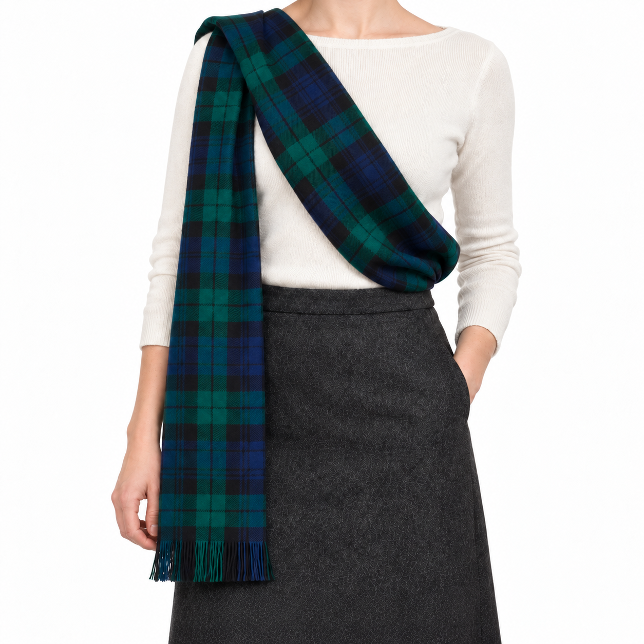 Black Watch tartan sash draped across an ivory top, with fringed end